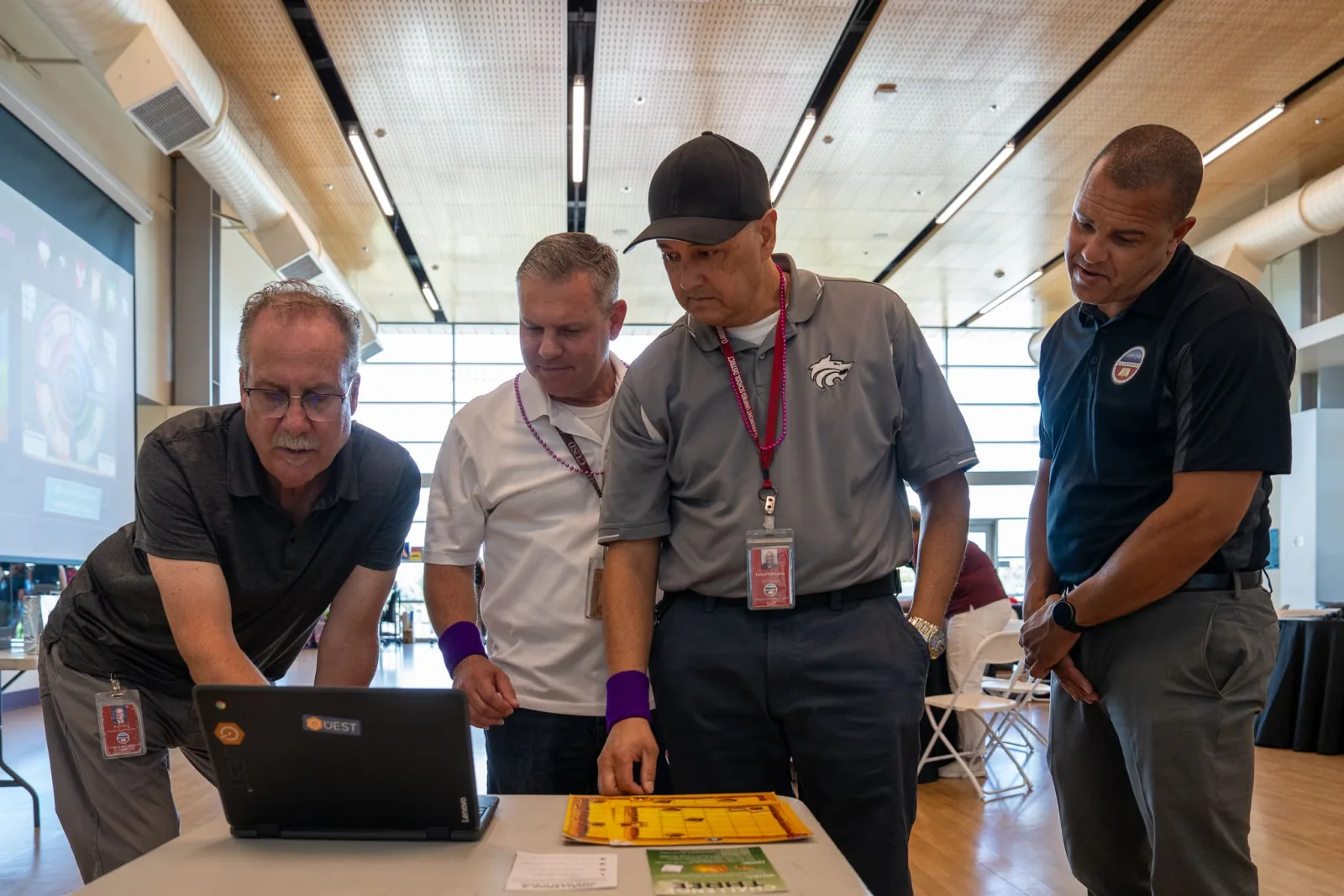 A leadership team reviewing their human skills report together on a laptop